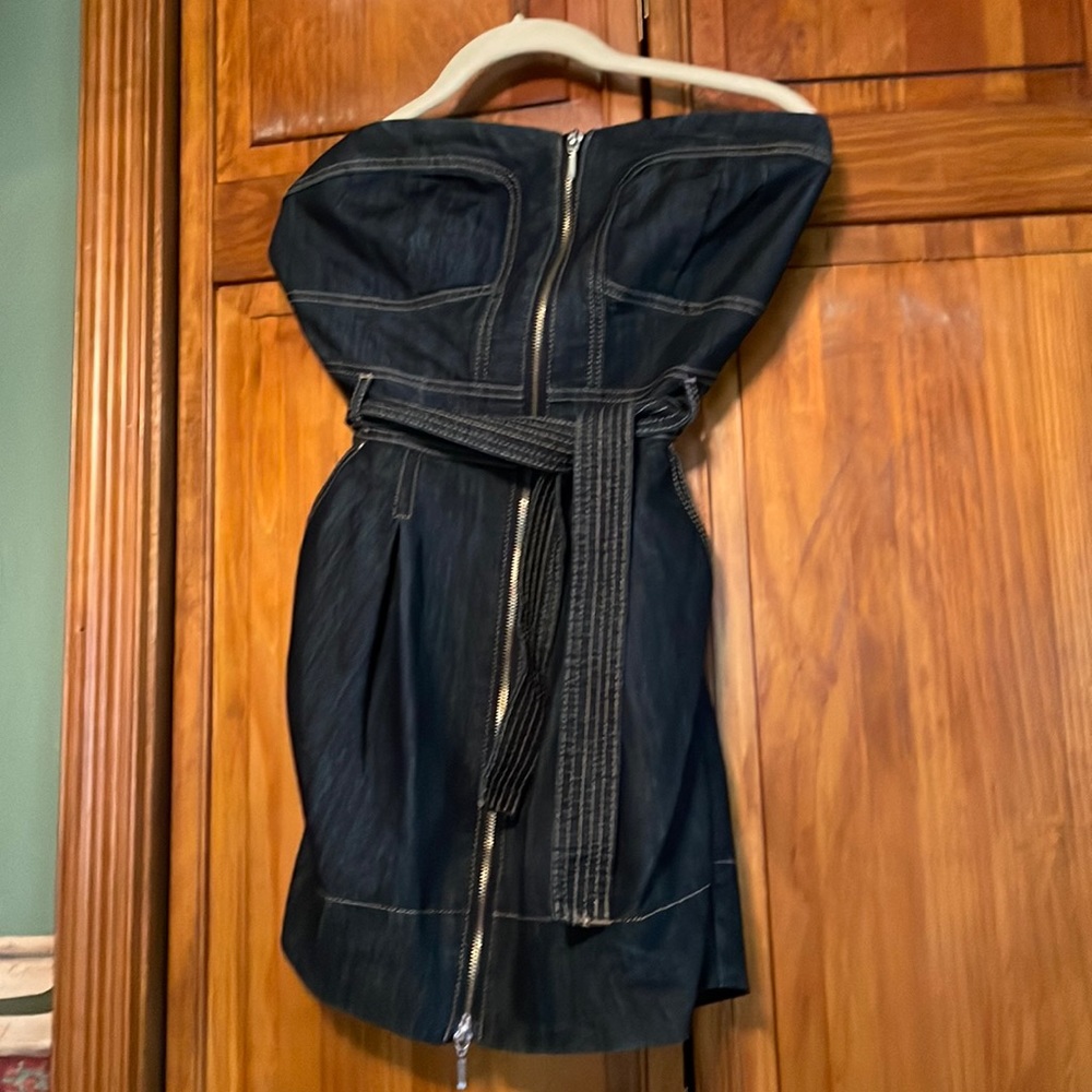 Sweet little denim dress with zipper closure,belt, and pockets.